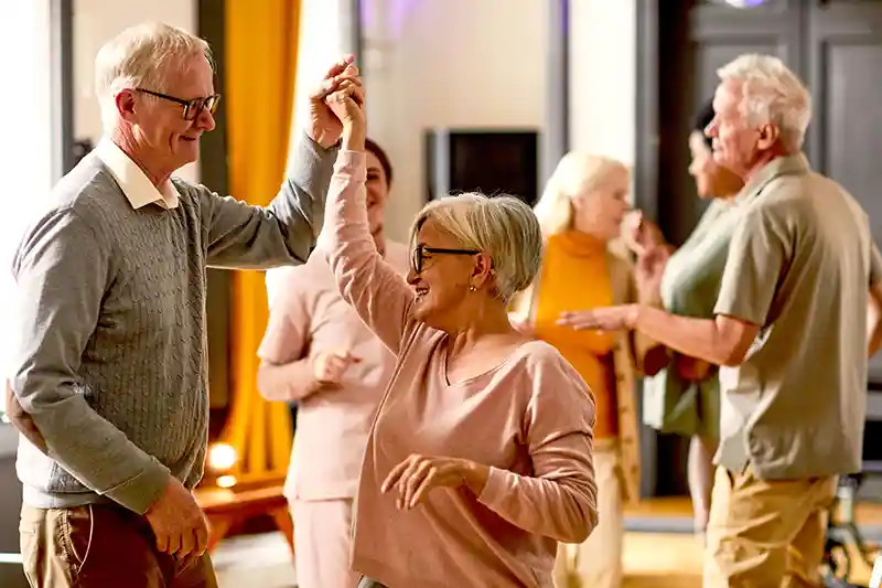 A group of seniors dancing at the Evergreen retirement community.